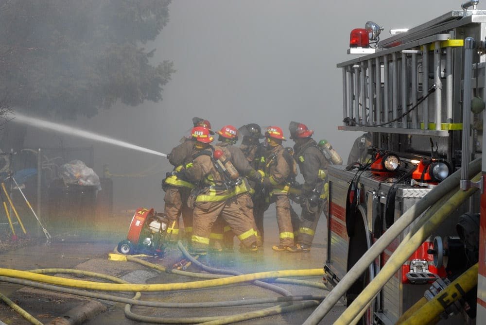 Firefighters putting water on fire